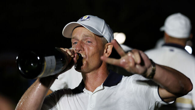 FARMINGDALE, NEW YORK - SEPTEMBER 28: Captain Luke Donald of Team Europe celebrates drinking champagne after Team Europe defeated Team United States 15-13 during the Sunday singles matches of the 2025 Ryder Cup at Black Course at Bethpage State Park Golf Course on September 28, 2025 in Farmingdale, New York.