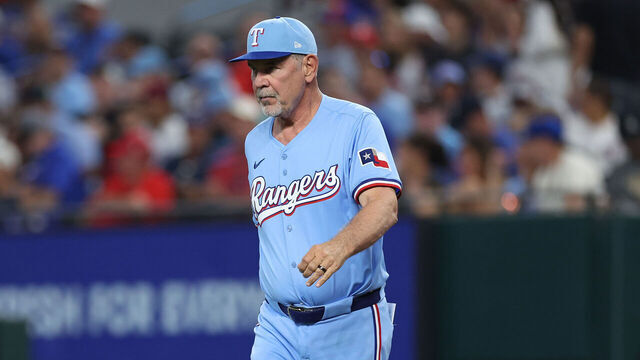 ARLINGTON, TEXAS - SEPTEMBER 21: Manager Bruce Bochy #15 of the Texas Rangers walks out to the mound during the fifth inning against the Miami Marlins at Globe Life Field on September 21, 2025 in Arlington, Texas.