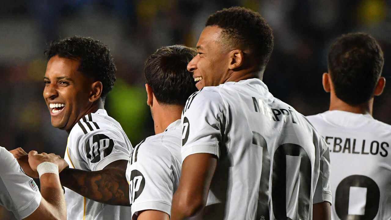 Real Madrid's French forward #10 Kylian Mbappe (R) celebrates scoring his team's third goal during the UEFA Champions League first round day 2 football match between Kairat Almaty and Real Madrid at the Almaty Ortalyk stadion in Almaty on September 30, 2025.