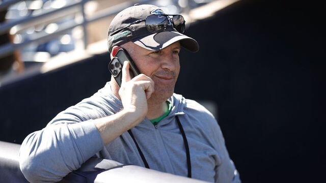 PEORIA, AZ - FEBRUARY 22: General Manager David Forst of the Athletics in the dugout before a spring training game against the San Diego Padres at Peoria Stadium on February 22, 2025 in Peoria, Arizona.