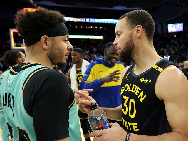 SAN FRANCISCO, CALIFORNIA - FEBRUARY 25: Stephen Curry #30 of the Golden State Warriors talks to his brother, Seth Curry #30 of the Charlotte Hornets, after their game at Chase Center on February 25, 2025 in San Francisco, California. NOTE TO USER: User expressly acknowledges and agrees that, by downloading and/or using this photograph, user is consenting to the terms and conditions of the Getty Images License Agreement.