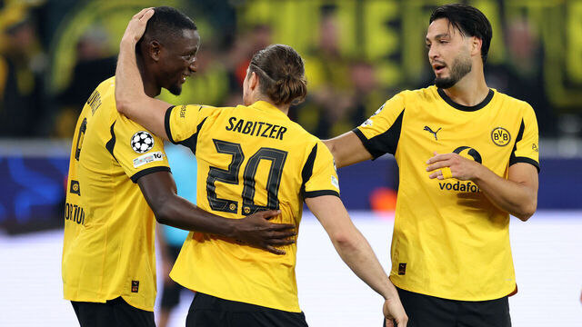 DORTMUND, GERMANY - OCTOBER 01: Serhou Guirassy of Borussia Dortmund celebrates scoring his team's third goal with teammate Marcel Sabitzer and Ramy Bensebaini during the UEFA Champions League 2025/26 League Phase MD2 match between Borussia Dortmund and Athletic Club at BVB Stadion Dortmund on October 01, 2025 in Dortmund, Germany.