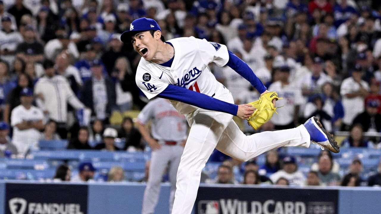 Los Angeles, CA - October 01: Relief pitcher Roki Sasaki #11 of the Los Angeles Dodgers throws to the plate against the Cincinnati Reds in the ninth inning of game 2 of a National League wild card series baseball game at Dodger Stadium in Los Angeles on Wednesday, October 1, 2025.