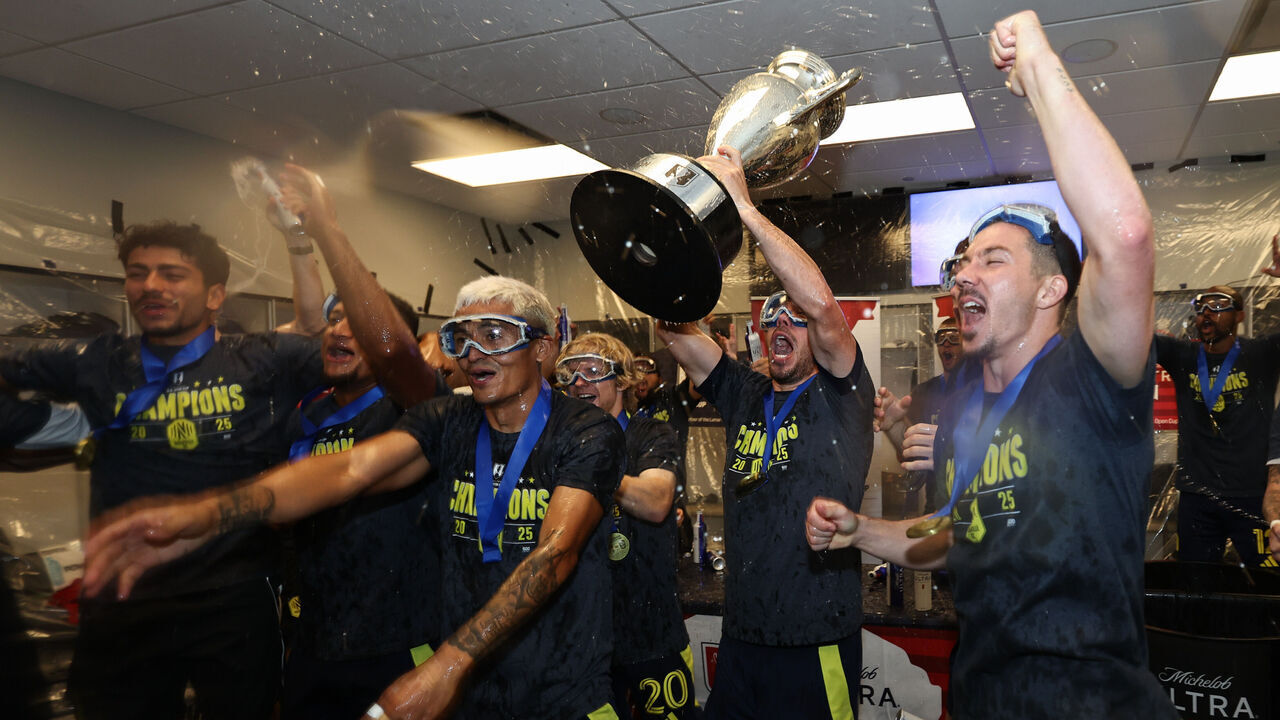AUSTIN, TEXAS - OCTOBER 01: Daniel Lovitz #2 of Nashville SC lifts the U.S. Open Cup trophy while celebrating with Nashville SC teammates in the locker room after Nashville SC defeated Austin FC to win the 2025 U.S. Open Cup Championship Final at Q2 Stadium on October 01, 2025 in Austin, Texas.