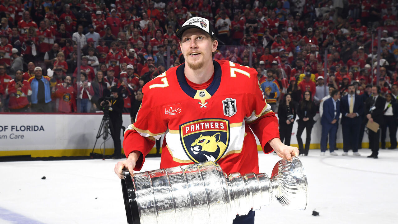 SUNRISE, FLORIDA - JUNE 17: Niko Mikkola #77 of the Florida Panthers celebrates with the Stanley Cup after Game Six of the 2025 Stanley Cup Final between the Edmonton Oilers and the Florida Panthers at Amerant Bank Arena on June 17, 2025 in Sunrise, Florida. The Panthers won the Stanley Cup Final series 4-2.
