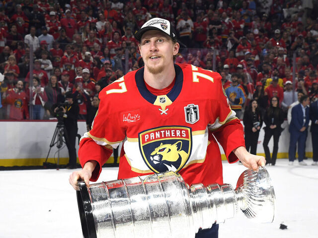 SUNRISE, FLORIDA - JUNE 17: Niko Mikkola #77 of the Florida Panthers celebrates with the Stanley Cup after Game Six of the 2025 Stanley Cup Final between the Edmonton Oilers and the Florida Panthers at Amerant Bank Arena on June 17, 2025 in Sunrise, Florida. The Panthers won the Stanley Cup Final series 4-2.