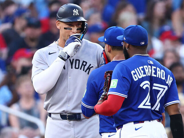 TORONTO, ON - JULY 02: Aaron Judge #99 of the New York Yankees talks to José Berríos #17 and Vladimir Guerrero Jr. #27 of the Toronto Blue Jays during a game at Rogers Centre on July 02, 2025 in Toronto, Ontario, Canada.