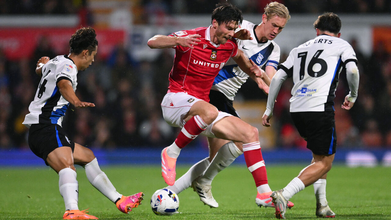 WREXHAM, WALES - OCTOBER 03: Kieffer Moore of Wrexham AFC controls the ball under pressure from Christoph Klarer of Birmingham City during the Sky Bet Championship match between Wrexham AFC and Birmingham City at Racecourse Ground on October 03, 2025 in Wrexham, Wales.