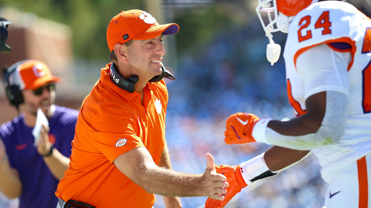 CHAPEL HILL, NC - OCTOBER 04: Dabo Swinney of the Clemson Tigers welcomes David Eziomume #24 of the Clemson Tigers back to the sidelines during the college football game between the North Carolina Tar Heels and the Clemson Tigers on October 4, 2025 at Kenan Memorial Stadium in Chapel Hill, NC.
