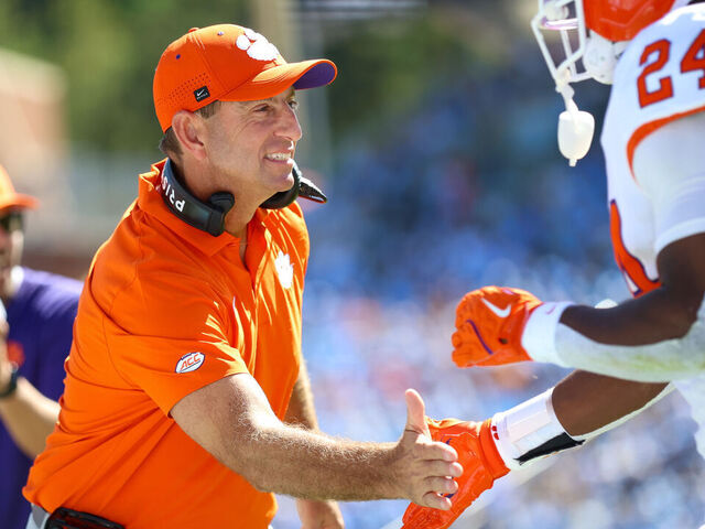 CHAPEL HILL, NC - OCTOBER 04: Dabo Swinney of the Clemson Tigers welcomes David Eziomume #24 of the Clemson Tigers back to the sidelines during the college football game between the North Carolina Tar Heels and the Clemson Tigers on October 4, 2025 at Kenan Memorial Stadium in Chapel Hill, NC.