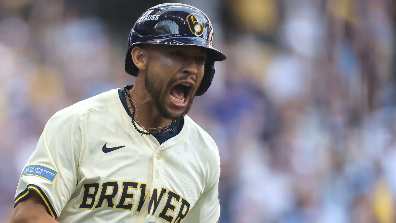 MILWAUKEE, WISCONSIN - OCTOBER 04: Blake Perkins #16 of the Milwaukee Brewers celebrates after hitting an RBI single against the Chicago Cubs during the first inning in game one of the Division Series at American Family Field on October 04, 2025 in Milwaukee, Wisconsin.