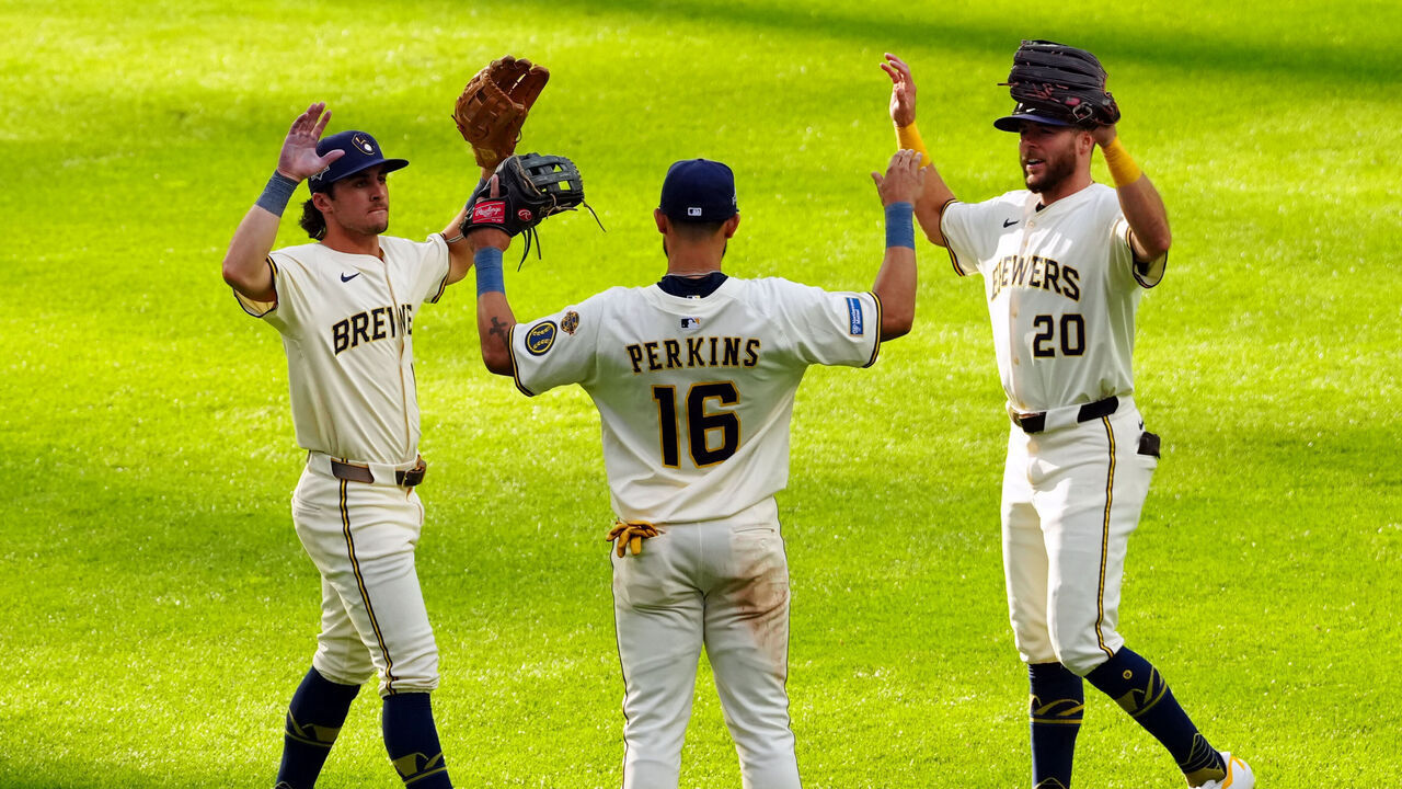 MILWAUKEE, WI - OCTOBER 04: Sal Frelick #10, Blake Perkins #16 and Brandon Lockridge #20 of the Milwaukee Brewers celebrates after the Brewers defeated the Chicago Cubs in Game One of the National League Division Series presented by Booking.com at American Family Field on Saturday, October 4, 2025 in Milwaukee, Wisconsin.
