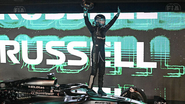 Mercedes' British driver George Russell celebrates his victory after the Formula One Singapore Grand Prix night race at the Marina Bay Street Circuit in Singapore on October 5, 2025.