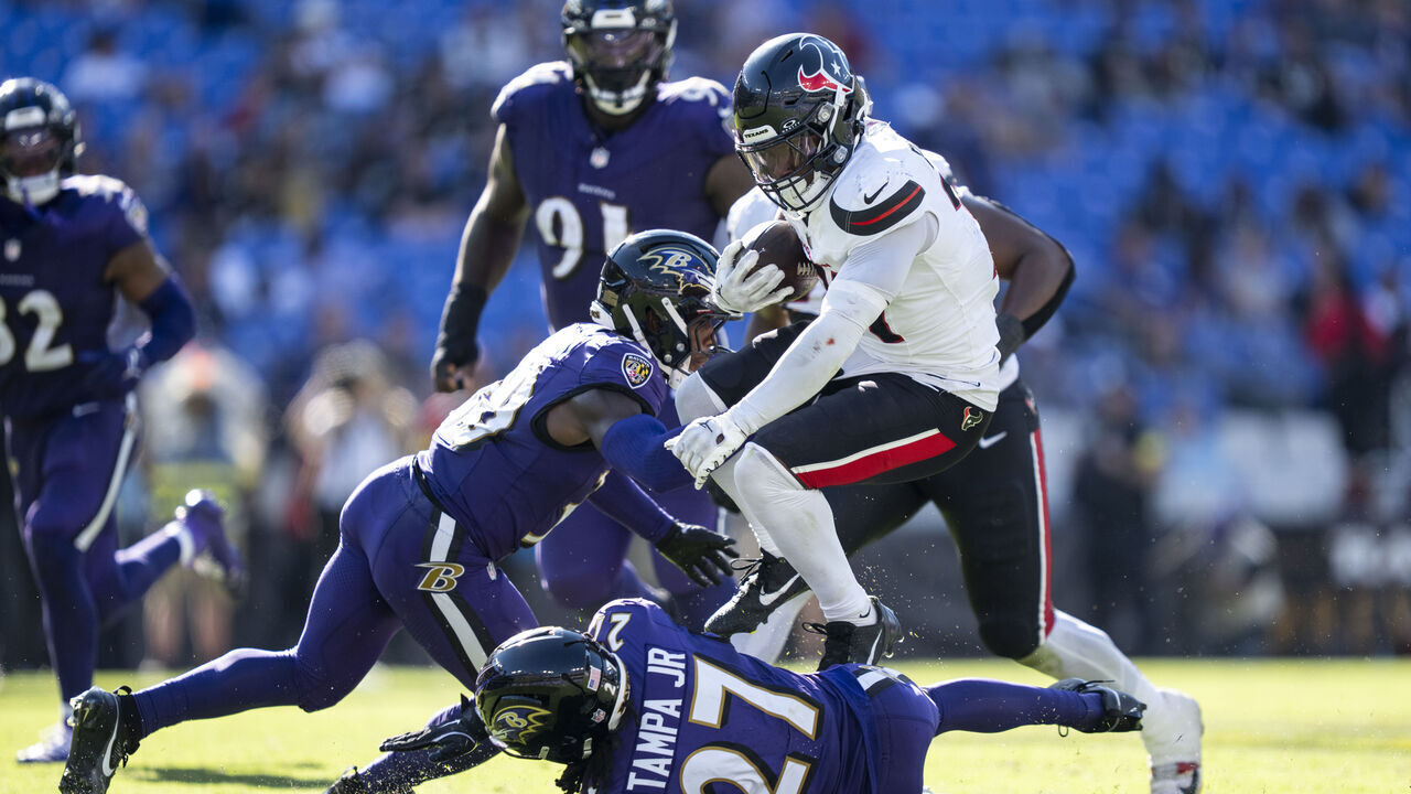 BALTIMORE, MARYLAND - OCTOBER 5: Dameon Pierce #31 of the Houston Texans hurdles against T.J. Tampa #27 of the Baltimore Ravens during an NFL football game at M&T Bank Stadium on October 05, 2025 in Baltimore, Maryland.