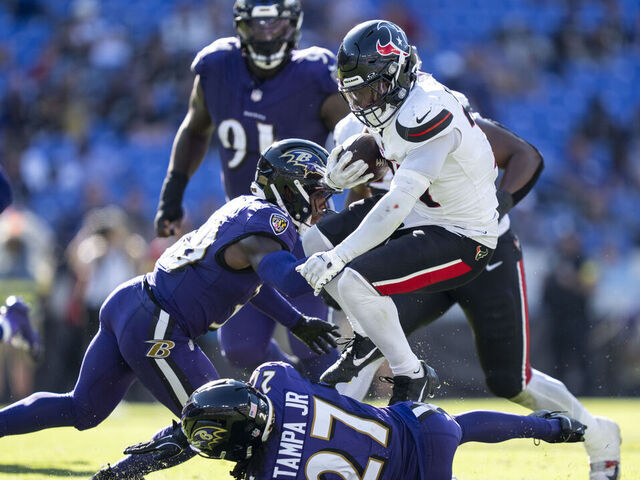 BALTIMORE, MARYLAND - OCTOBER 5: Dameon Pierce #31 of the Houston Texans hurdles against T.J. Tampa #27 of the Baltimore Ravens during an NFL football game at M&T Bank Stadium on October 05, 2025 in Baltimore, Maryland.