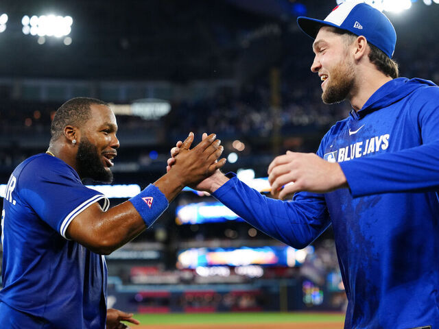 TORONTO, ON - OCTOBER 05: Vladimir Guerrero Jr. #27 and Trey Yesavage #39 of the Toronto Blue Jays celebrate after winning Game Two of the American League Division Series presented by Booking.com between the New York Yankees and the Toronto Blue Jays at Rogers Centre on Sunday, October 5, 2025 in Toronto, Ontario, Canada.