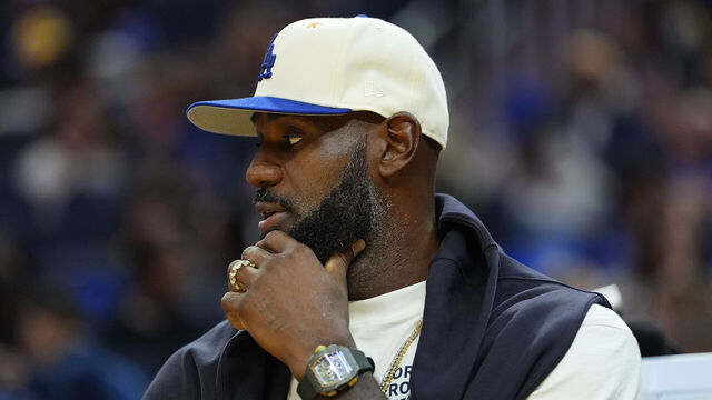 SAN FRANCISCO, CALIFORNIA - OCTOBER 05: Lebron James #23 of the Los Angeles Lakers looks on from the bench against the Golden State Warriors in the first half of a preseason NBA game at Chase Center on October 05, 2025 in San Francisco, California.