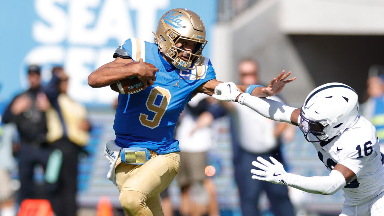 PASADENA, CA - OCTOBER 04: UCLA Bruins quarterback Nico Iamaleava (9) fends off Penn State Nittany Lions safety King Mack (16) during the college football game between the Penn State Nittany Lions and the UCLA Bruins on October 04, 2025, at the Rose Bowl in Pasadena, CA.