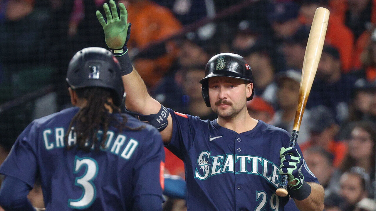 DETROIT, MICHIGAN - OCTOBER 07: J.P. Crawford #3 of the Seattle Mariners is congratulated by Cal Raleigh #29 after scoring a run against the Seattle Mariners during the third inning in game three of the American League Division Series at Comerica Park on October 07, 2025 in Detroit, Michigan.