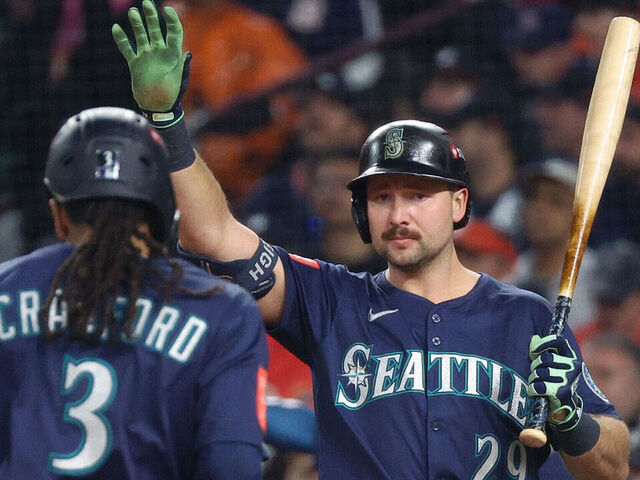 DETROIT, MICHIGAN - OCTOBER 07: J.P. Crawford #3 of the Seattle Mariners is congratulated by Cal Raleigh #29 after scoring a run against the Seattle Mariners during the third inning in game three of the American League Division Series at Comerica Park on October 07, 2025 in Detroit, Michigan.