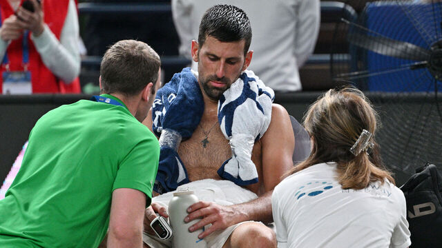 Serbia's Novak Djokovic receives medical attention during his men's singles match against Spain's Jaume Munar at the Shanghai Masters tennis tournament in Shanghai on October 7, 2025.