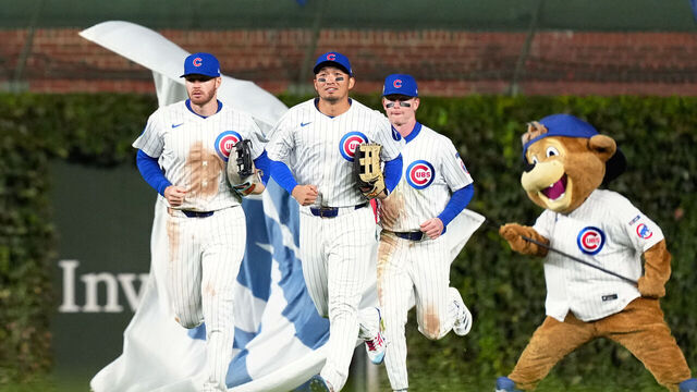 CHICAGO, IL - OCTOBER 08: Pete Crow-Armstrong #4, Ian Happ #8, Seiya Suzuki #27 of the Chicago Cubs and Chicago Cubs mascot Clark celebrates after the Cubs defeated the Milwaukee Brewers in Game Three of the National League Division Series presented by Booking.com at Wrigley Field on Wednesday, October 8, 2025 in Chicago, Illinois.