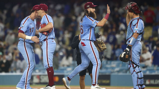LOS ANGELES, CA - OCTOBER 08: Max Kepler #17, Tanner Banks #58, Brandon Marsh #16 and J.T. Realmuto #10 of the Philadelphia Phillies celebrate after winning Game Three of the National League Division Series presented by Booking.com between the Philadelphia Phillies and the Los Angeles Dodgers at Dodger Stadium on Wednesday, October 8, 2025 in Los Angeles, California.