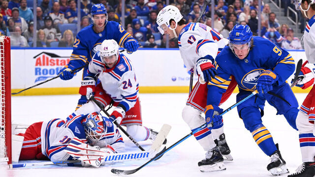 BUFFALO, NEW YORK - OCTOBER 09: Igor Shesterkin #31 makes a save as Will Borgen #17 of the New York Rangers defends against Josh Doan #91 of the Buffalo Sabres during the second period of an NHL game at KeyBank Center on October 9, 2025 in Buffalo, New York.
