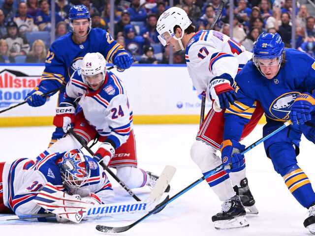 BUFFALO, NEW YORK - OCTOBER 09: Igor Shesterkin #31 makes a save as Will Borgen #17 of the New York Rangers defends against Josh Doan #91 of the Buffalo Sabres during the second period of an NHL game at KeyBank Center on October 9, 2025 in Buffalo, New York.