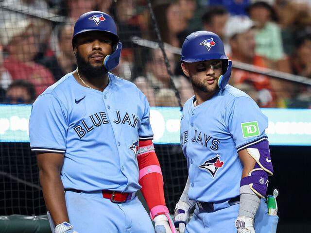 BALTIMORE, MD - JULY 29: Vladimir Guerrero Jr. #27 and Bo Bichette #11 of the Toronto Blue Jays look on during the seventh inning in game two of a split doubleheader against the Baltimore Orioles at Oriole Park at Camden Yards on July 29, 2025 in Baltimore, Maryland.
