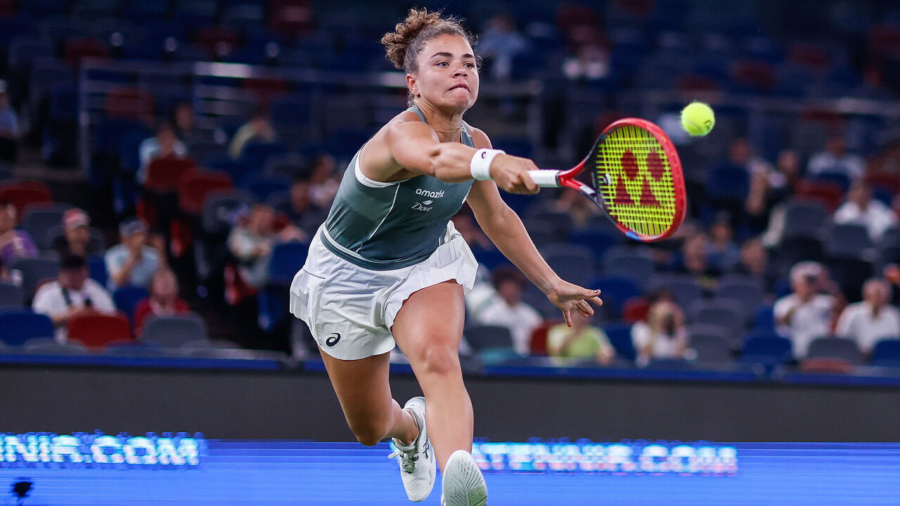 WUHAN, CHINA - OCTOBER 10: Jasmine Paolini of Italy returns a shot against Iga Świątek of Poland in the Women's Singles Round of 8 match during day seven of the 2025 Wuhan Open at Optics Valley International Tennis Center on October 10, 2025 in Wuhan, China.