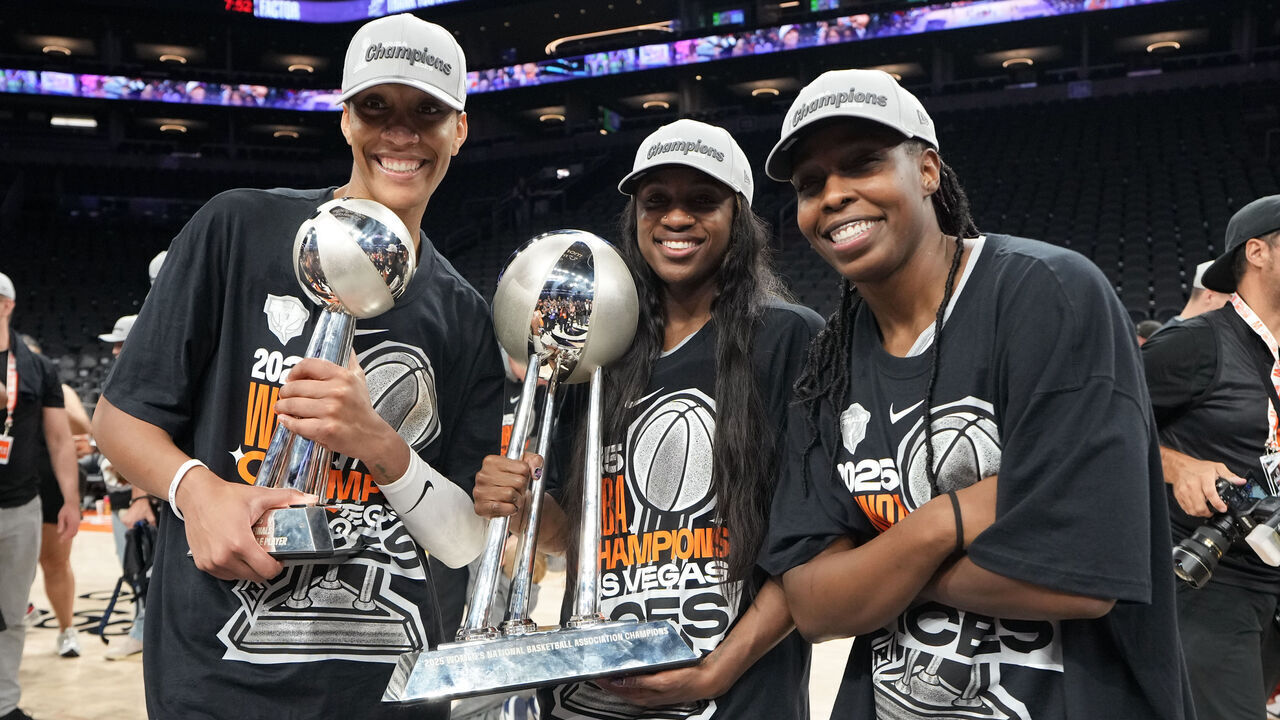 PHOENIX, AZ - OCTOBER 10: A'ja Wilson #22, Jackie Young #0, and Chelsea Gray #12 of the Las Vegas Aces pose for a photo with the 2025 WNBA Championship trophy after winning the game against the Phoenix Mercury on October 10, 2025 at PHX Arena in Phoenix, Arizona. Mandatory Copyright Notice: Copyright 2025 NBAE
