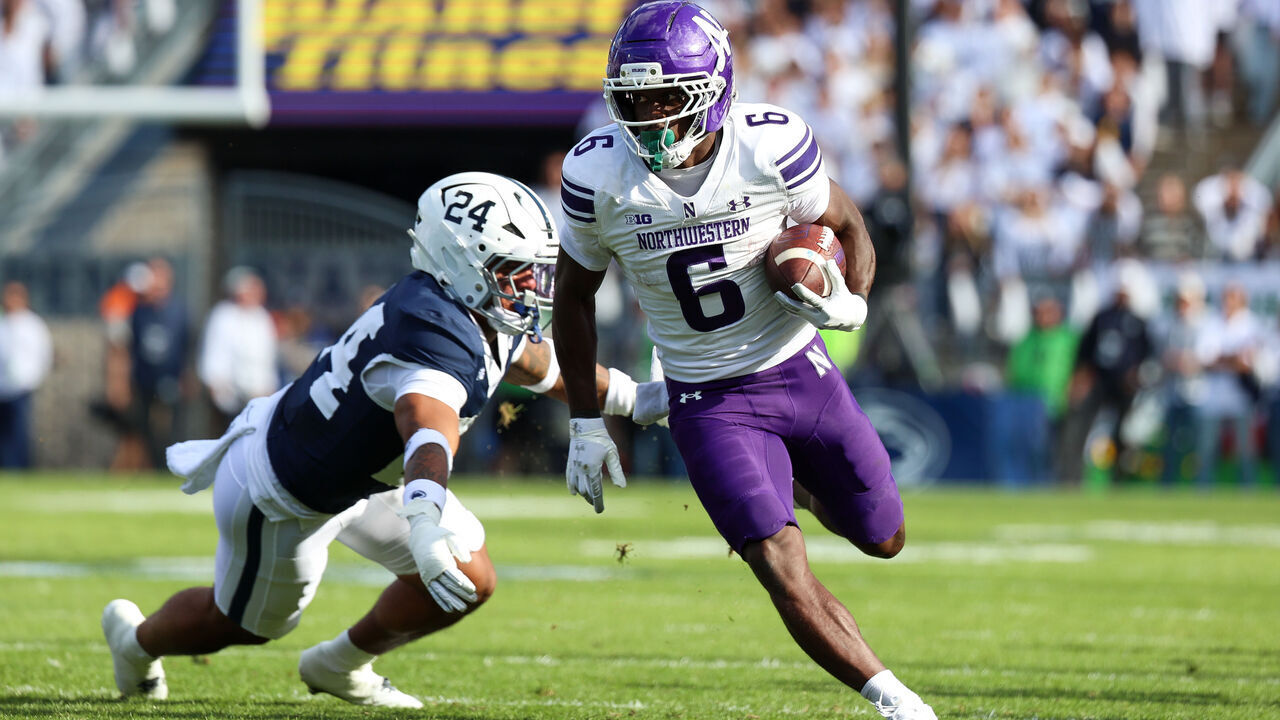 STATE COLLEGE, PENNSYLVANIA - OCTOBER 11: Joseph Himon II #6 of the Northwestern Wildcats runs the ball against Corey Smith #24 of the Penn State Nittany Lions during the first quarter at Beaver Stadium on October 11, 2025 in State College, Pennsylvania.
