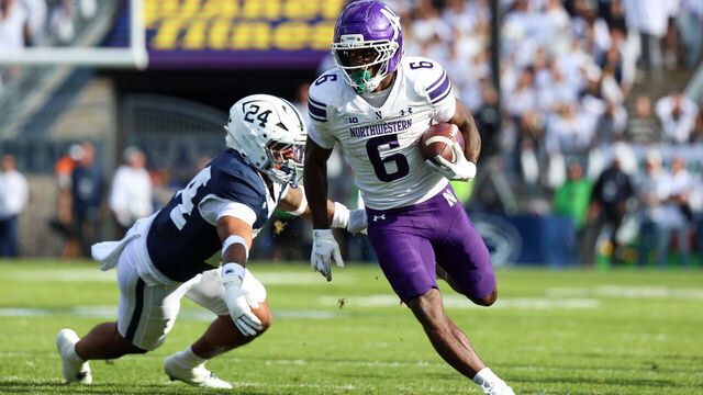 STATE COLLEGE, PENNSYLVANIA - OCTOBER 11: Joseph Himon II #6 of the Northwestern Wildcats runs the ball against Corey Smith #24 of the Penn State Nittany Lions during the first quarter at Beaver Stadium on October 11, 2025 in State College, Pennsylvania.