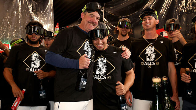 SEATTLE, WASHINGTON - OCTOBER 10: Manager Dan Wilson #6 of the Seattle Mariners and Leo Rivas #76 of the Seattle Mariners celebrates in the locker room after the team's 3-2 win against the Detroit Tigers in game five of the American League Division Series at T-Mobile Park on October 10, 2025 in Seattle, Washington.