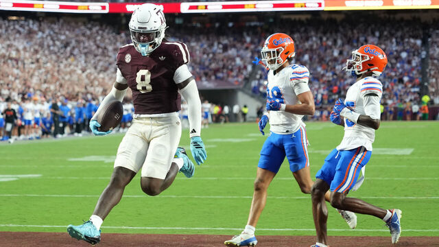 COLLEGE STATION, TEXAS - OCTOBER 11: Le'Veon Moss #8 of Texas A&M runs in to the end zone for a touchdown past Jordan Pride #28 and Dalton Brooks #25 of the Florida Gators during the first half at Kyle Field on October 11, 2025 in College Station, Texas.
