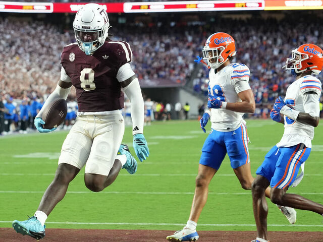 COLLEGE STATION, TEXAS - OCTOBER 11: Le'Veon Moss #8 of Texas A&M runs in to the end zone for a touchdown past Jordan Pride #28 and Dalton Brooks #25 of the Florida Gators during the first half at Kyle Field on October 11, 2025 in College Station, Texas.