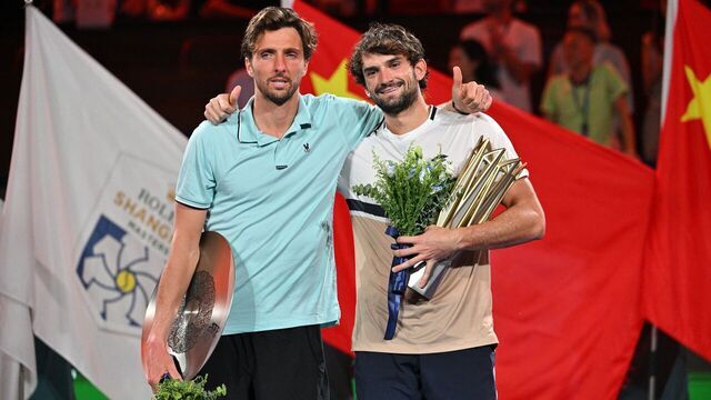 Monaco's Valentin Vacherot (R) poses with the trophy after his victory against France's Arthur Rinderknech (L) during the men's singles final at the Shanghai Masters tennis tournament in Shanghai on October 12, 2025.