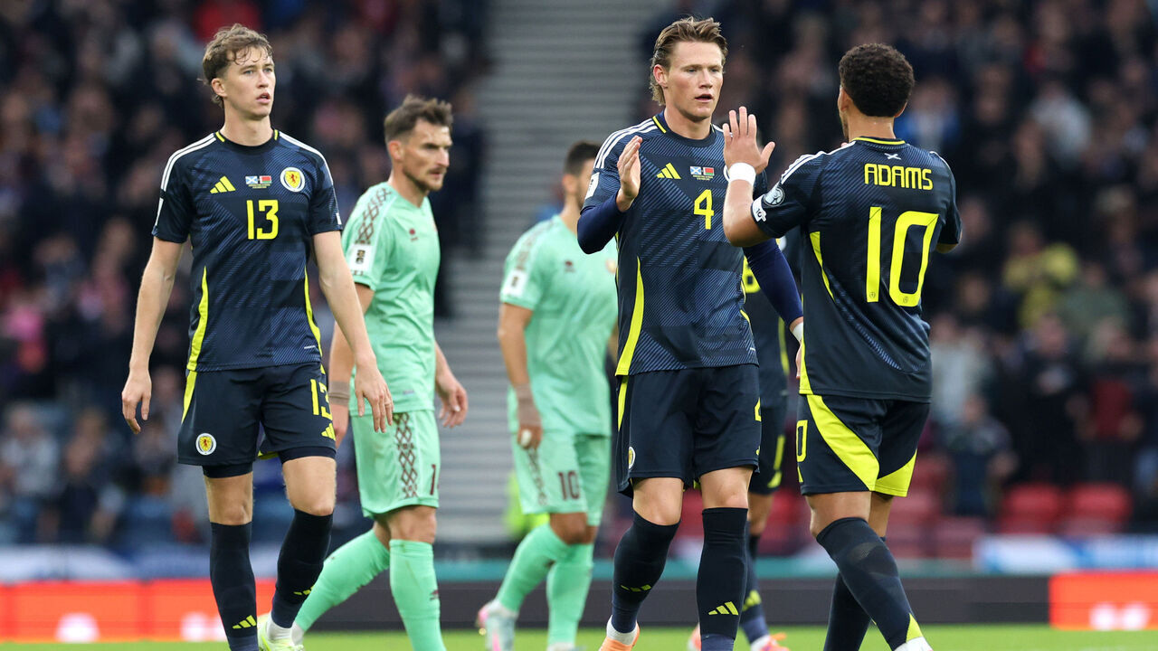 GLASGOW, SCOTLAND - OCTOBER 12: Che Adams of Scotland celebrates with Scott McTominay after scoring his team's first goal during the FIFA World Cup 2026 qualifier match between Scotland and Belarus at Hampden Park on October 12, 2025 in Glasgow, Scotland.