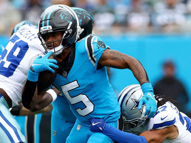 CHARLOTTE, NORTH CAROLINA - OCTOBER 12: Reddy Steward #27 of the Dallas Cowboys attempts to tackle Rico Dowdle #5 of the Carolina Panthers during the second quarter in the game at Bank of America Stadium on October 12, 2025 in Charlotte, North Carolina.