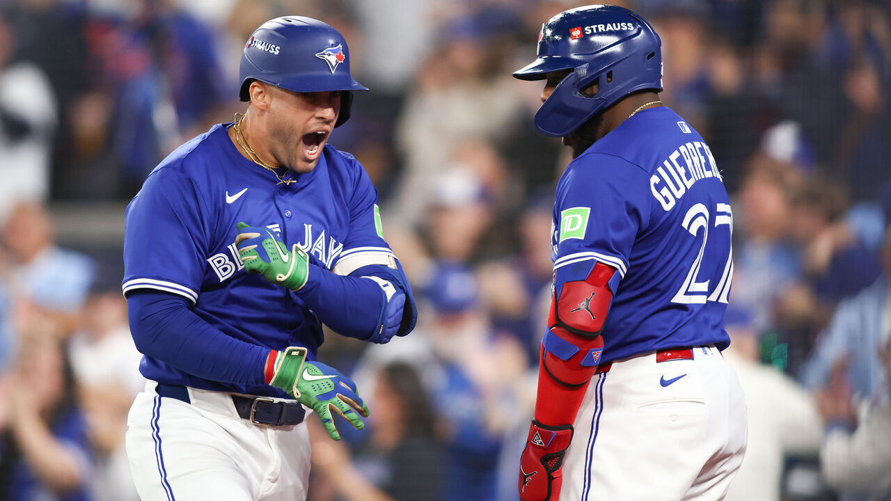 TORONTO, ONTARIO - OCTOBER 12: George Springer #4 of the Toronto Blue Jays is congratulated by Vladimir Guerrero Jr. #27 after hitting a solo home run against the Seattle Mariners during the first inning in game one of the American League Championship Series at Rogers Centre on October 12, 2025 in Toronto, Ontario.