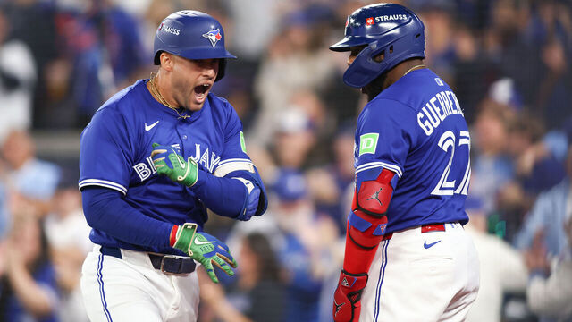TORONTO, ONTARIO - OCTOBER 12: George Springer #4 of the Toronto Blue Jays is congratulated by Vladimir Guerrero Jr. #27 after hitting a solo home run against the Seattle Mariners during the first inning in game one of the American League Championship Series at Rogers Centre on October 12, 2025 in Toronto, Ontario.