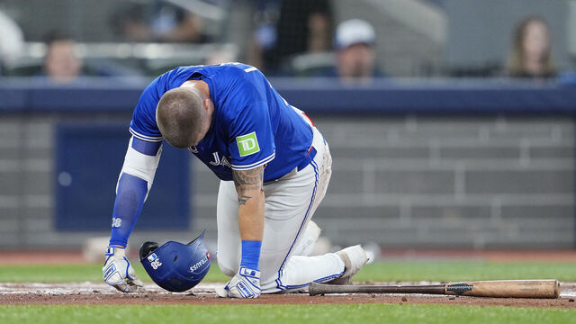TORONTO, ONTARIO - OCTOBER 12: Nathan Lukes #38 of the Toronto Blue Jays reacts after fouling a ball off his leg during the first inning against the Seattle Mariners in game one of the American League Championship Series at Rogers Centre on October 12, 2025 in Toronto, Ontario.