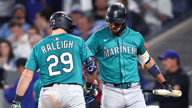 TORONTO, ONTARIO - OCTOBER 12: Cal Raleigh #29 of the Seattle Mariners celebrates with Julio Rodriguez #44 after hitting a solo home run against the Toronto Blue Jays during the sixth inning in game one of the American League Championship Series at Rogers Centre on October 12, 2025 in Toronto, Ontario.