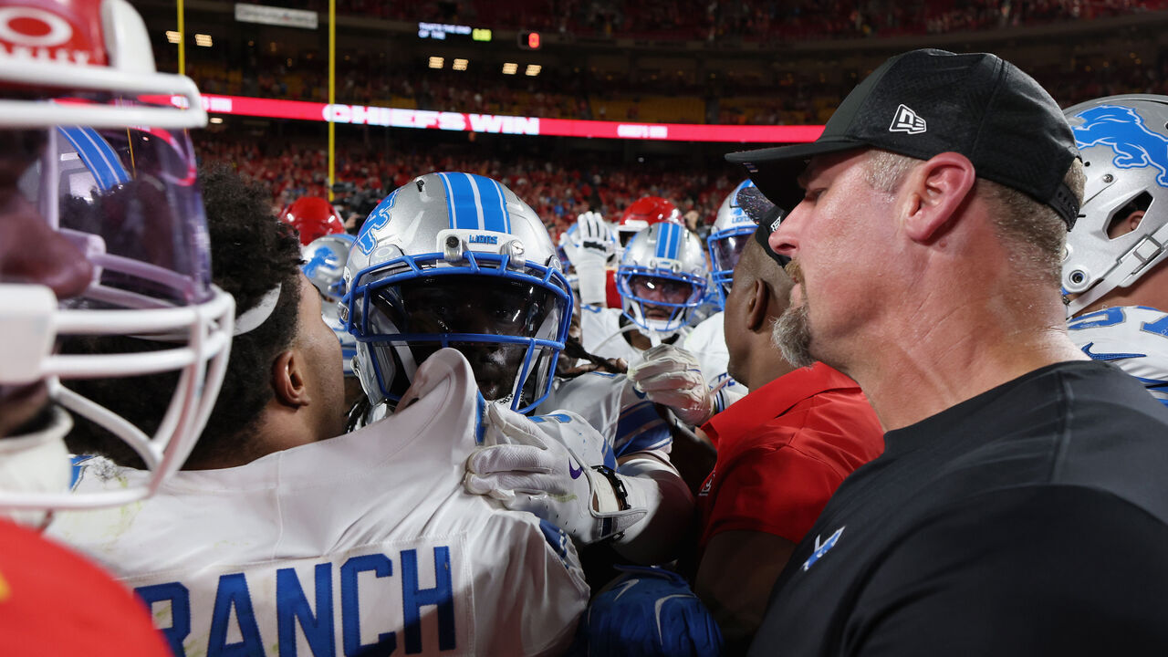 KANSAS CITY, MISSOURI - OCTOBER 12: Head coach Dan Campbell of the Detroit Lions speaks to Brian Branch #32 after the game against the Kansas City Chiefs at Arrowhead Stadium on October 12, 2025 in Kansas City, Missouri.