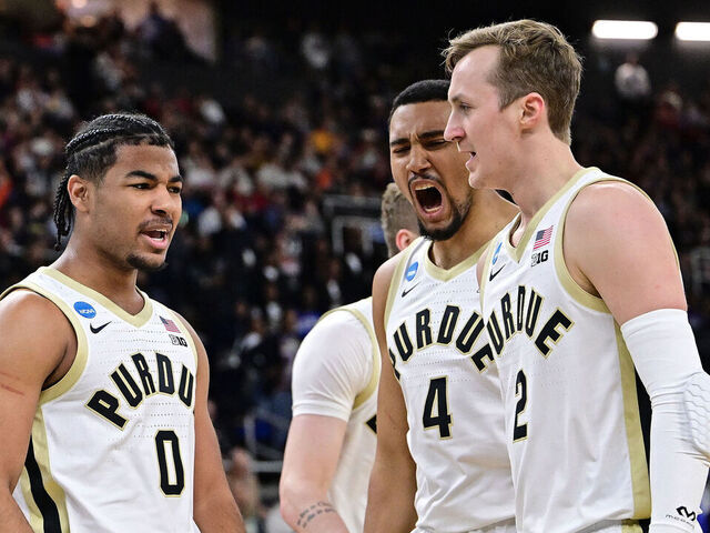 PROVIDENCE, RHODE ISLAND - MARCH 22: C.J. Cox #0, Trey Kaufman-Renn #4, and Fletcher Loyer #2 of the Purdue Boilermakers celebrate a basket agains the McNeese Cowboys during the second round of the 2025 NCAA Men's Basketball Tournament held at Amica Mutual Pavillion on March 22, 2025 in Providence, Rhode Island.