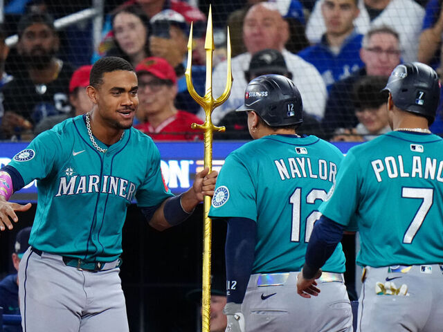 TORONTO, ON - OCTOBER 13: Josh Naylor #12 of the Seattle Mariners celebrates with Julio Rodríguez #44 after hitting a two-run home run in the seventh inning during Game Two of the American League Championship Series presented by loanDepot between the Seattle Mariners and the Toronto Blue Jays at Rogers Centre on Monday, October 13, 2025 in Toronto, Ontario, Canada.