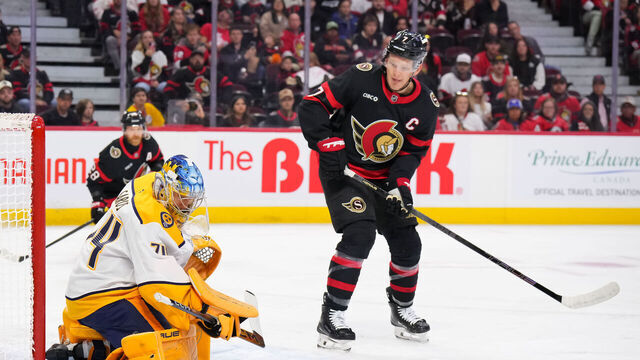 OTTAWA, CANADA - OCTOBER 13: Juuse Saros #74 of the Nashville Predators makes a save against the Ottawa Senators as Brady Tkachuk #7 of the Ottawa Senators looks for the loose puck during the first period on October 13, 2025 at Canadian Tire Centre in Ottawa, Ontario, Canada.