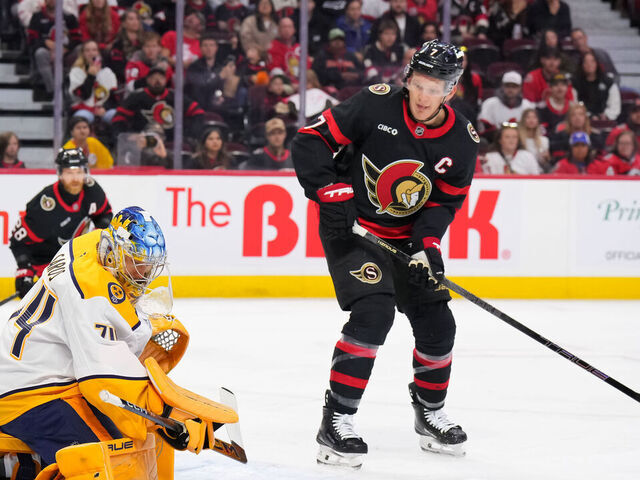OTTAWA, CANADA - OCTOBER 13: Juuse Saros #74 of the Nashville Predators makes a save against the Ottawa Senators as Brady Tkachuk #7 of the Ottawa Senators looks for the loose puck during the first period on October 13, 2025 at Canadian Tire Centre in Ottawa, Ontario, Canada.