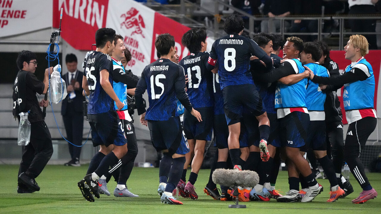 CHOFU, JAPAN - OCTOBER 14: Ayase Ueda of Japan (obscured) celebrates with teammates after scoring the team's third goal during the international friendly match between Japan and Brazil at Tokyo Stadium on October 14, 2025 in Chofu, Tokyo, Japan.